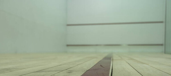 selective focus on a section of wood planking at floor level inside a racquet ball court. High quality photo