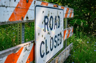 Buckshot road closed sign in front of a washed out bridge. High quality photo
