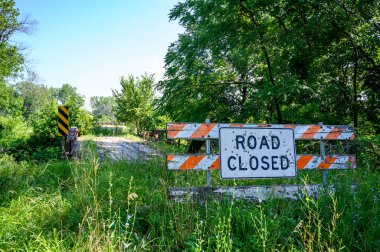 Buckshot road closed sign in front of a washed out bridge. High quality photo
