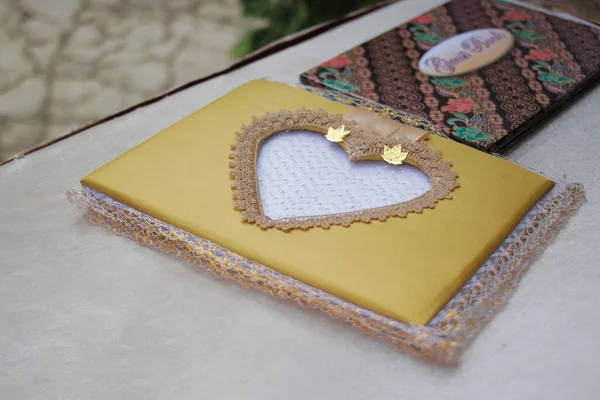 Brown wedding guest book with love shaped on the table