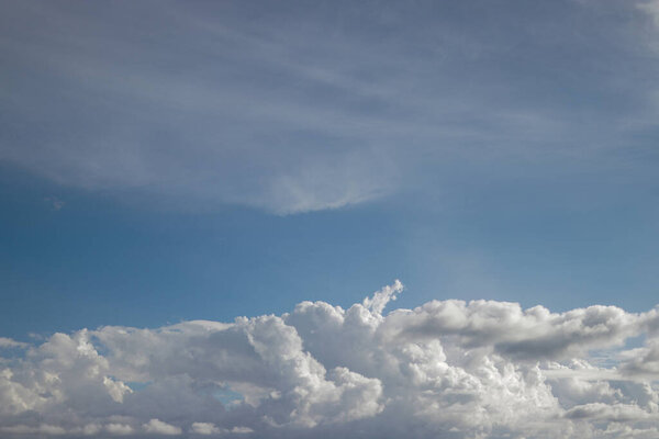 Cumulus clouds with a clear blue sky background in the midday. Types of clouds stock images.