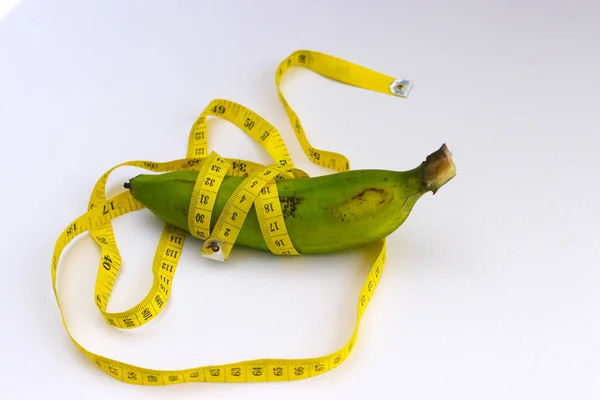 Close View Green Banana Wrapped Yellow Measuring Tape Isolated White — Fotografia de Stock