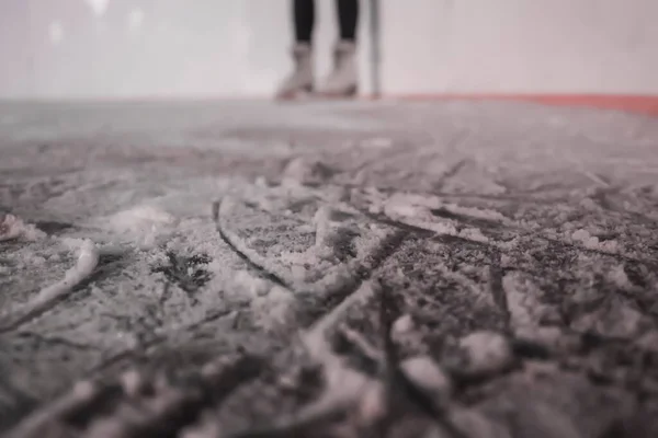 ice rink with blurred one ice skates feets
