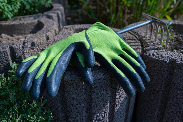 Garden work. Gloves for gardening. Gardening. Green gardening gloves