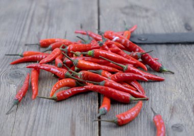 Close up fresh red hot chilli on wooden table background. High quality photo