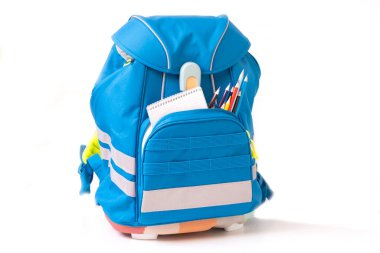 Classic colored school backpack with supplies. Preparation for school.