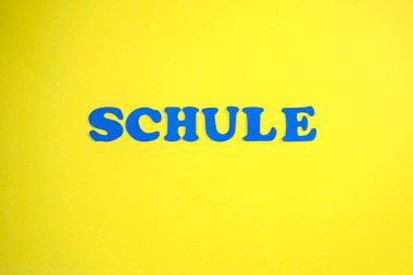 Word Schule Means School. Yellow background, blue letters