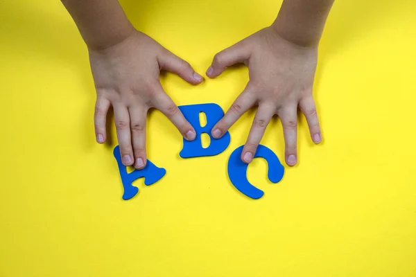 Childrens Hands Hold Letters Blue Letters Yellow Background High Quality —  Fotos de Stock