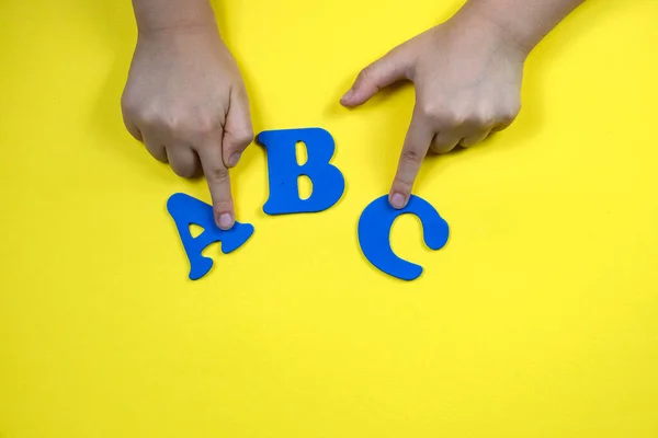 Childrens Hands Yellow Background Blue Letters Concept Teaching Children School —  Fotos de Stock