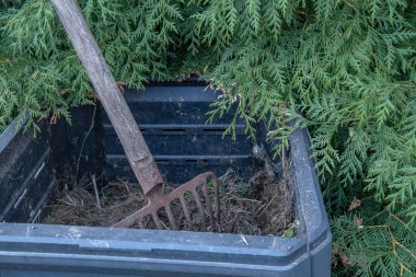 Garden shovel on compost. Compost preparation. Compost box in autumn.