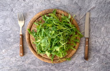 Fresh arugula Eruca sativa on a wooden board. Healthy lunch. Healthy food concept