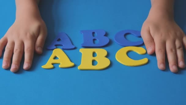 Childs Hand Playing Letters Alphabet Blue Yellow Letters Alphabet School — Vídeo de stock