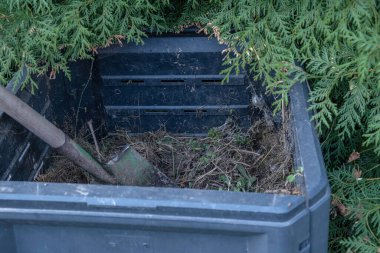 Compost bin in the garden. Garden shovel. Organic garden concept. High quality photo