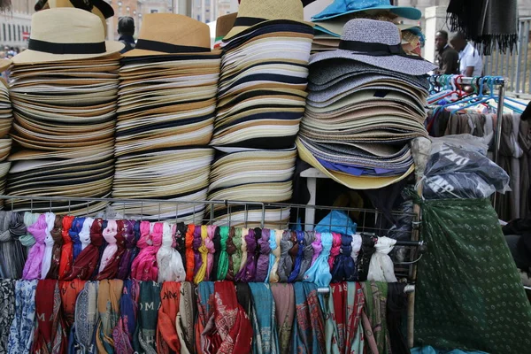 The colorful hats are stacked up high on the display rack.