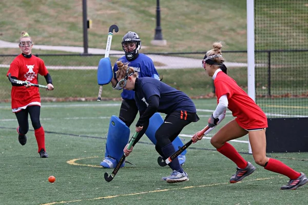 The goalkeeper runs out to make a save in this important match.