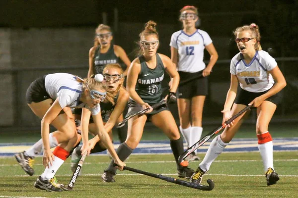 The game action is fast and furious and the ball is top of the players head.