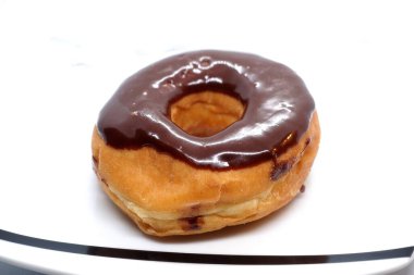 The chocolate covered  donut looks delicious.