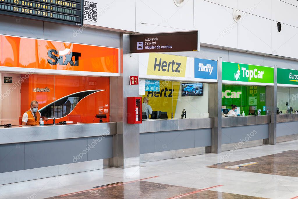 Tenerife, Spain - September, 2021: Car rental counters from various rent a car companies in airpot