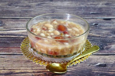 Rice congee made with red beans, lotus seeds, longan, red dates, and nuts. Sweet congee, Selective focus clipart