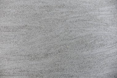 Sand background and texture. Wet beach sand texture after low tide. Sand with wave print. Ripple on the beach sand. 