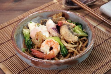 Hokkien Mee (Mee Pad Hokkien) the famous Stir-fried seafood Noodles. Phuket Original Hokkien Noodles consists of thick yellow (egg) noodles fried with seafood, pork and vegetables. Selective focus