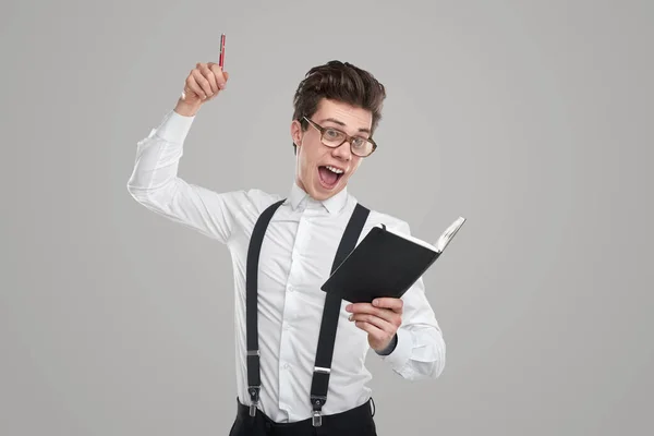 Excited man with notebook and pen — Stock Photo, Image