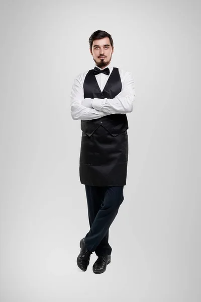 Confident waiter in uniform with arms crossed — Stock Photo, Image