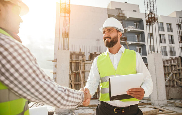 Engineers shaking hands at construction site