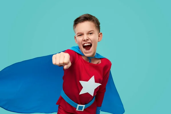 Excited superhero flying on blue background — Stock Photo, Image
