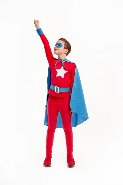 Superhero kid with arm raised in flight — Stock Photo, Image