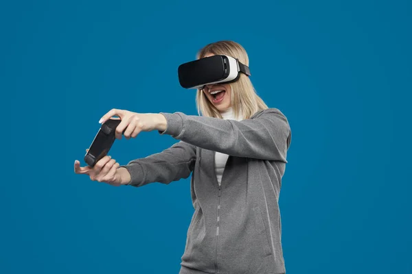 Excited woman in VR glasses playing videogame — Stock Photo, Image