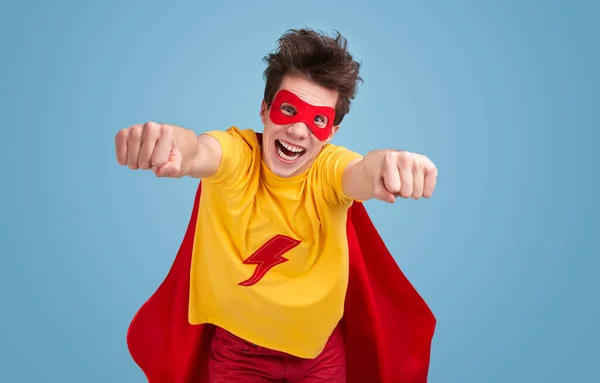 Comic superhero flying in studio — Stock Photo, Image