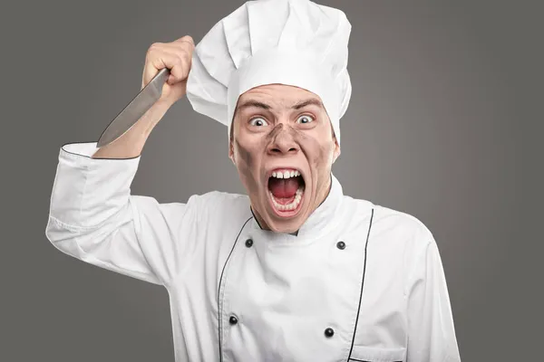 Screaming dirty chef threatening with knife — Stock Photo, Image