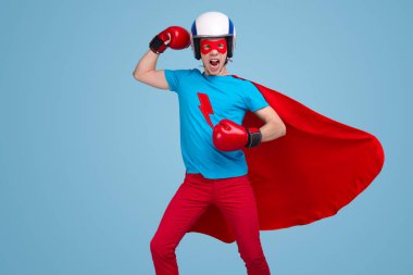Stüdyoda boks eldivenli komik bir süper kahraman.