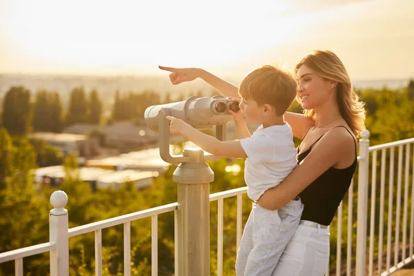 Mother and son using binoculars on viewpoint — Stock Photo, Image