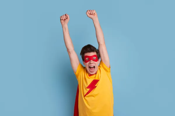 Excited superhero man flying in studio — Stock Photo, Image