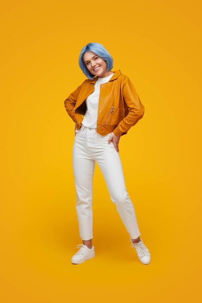 Smiling stylish woman with blue hair in studio