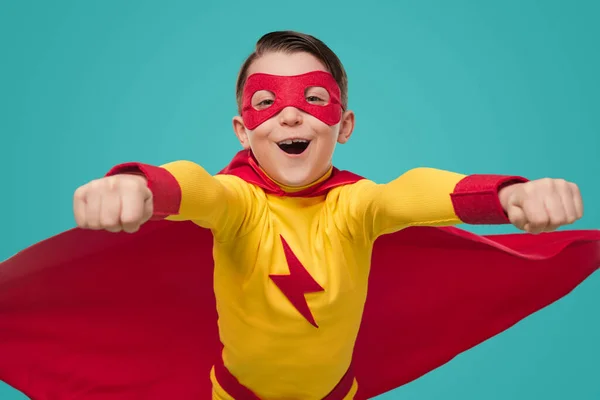 Strong superhero boy flying towards camera — Stock Photo, Image