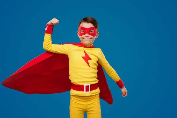 Strong superhero boy showing muscles in studio — Stock Photo, Image