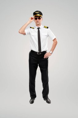 Stüdyoda üniformalı, kendinden emin bir pilot.