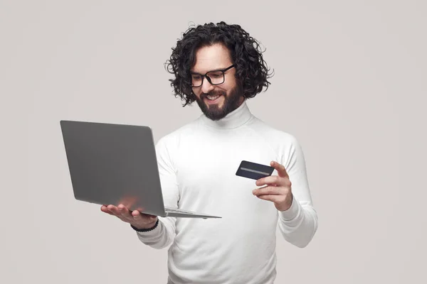 Smiling man making online purchase with plastic card — Photo
