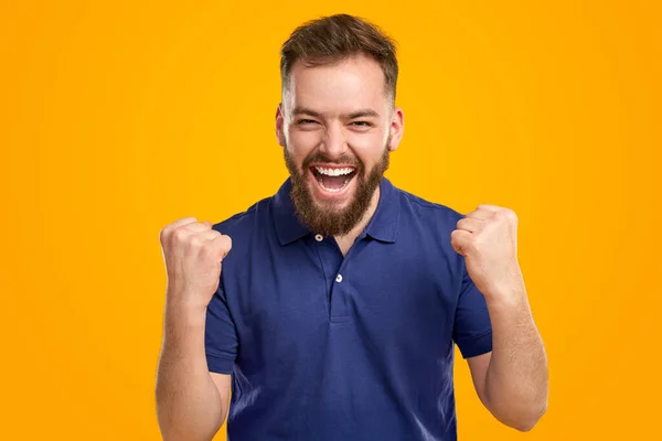 Positive man celebrating victory with clenched fists — Stock Fotó