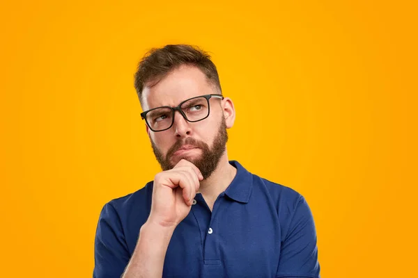 Thoughtful smart man rubbing chin — стоковое фото