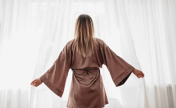 Woman in robe enjoying morning at home — Stok Foto