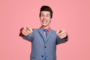 Comic businessman pointing at camera with you gesture