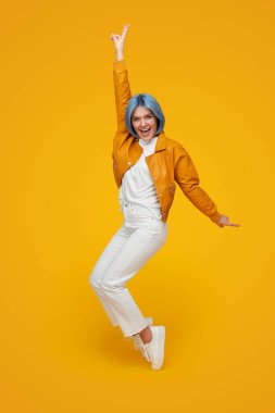 Cool hipster standing on tiptoes in studio