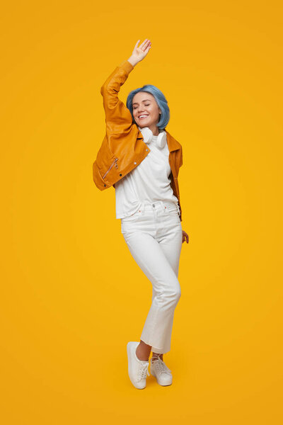 Delighted woman dancing in studio