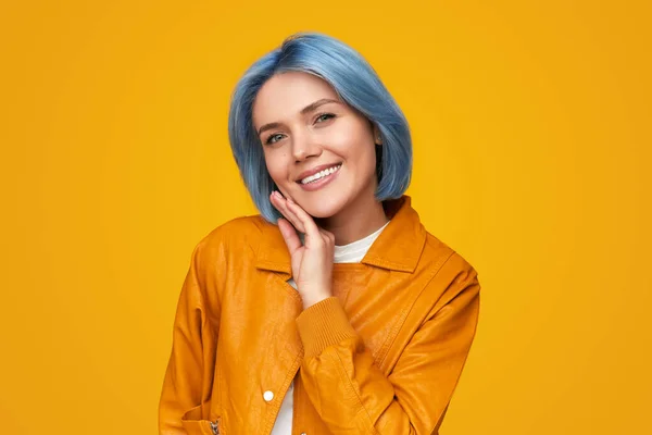 Smiling woman touching face and looking at camera — Stock Photo, Image