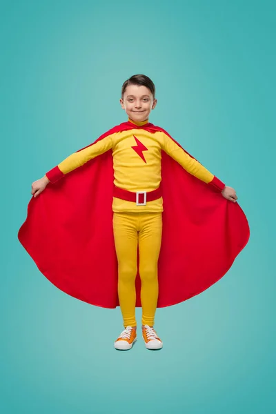 Superhero child in red cloak in studio — Stock Photo, Image