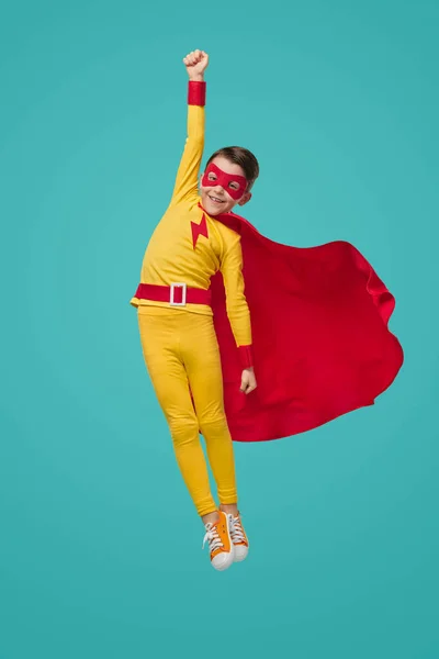 Superhero kid flying with raised arm — Φωτογραφία Αρχείου